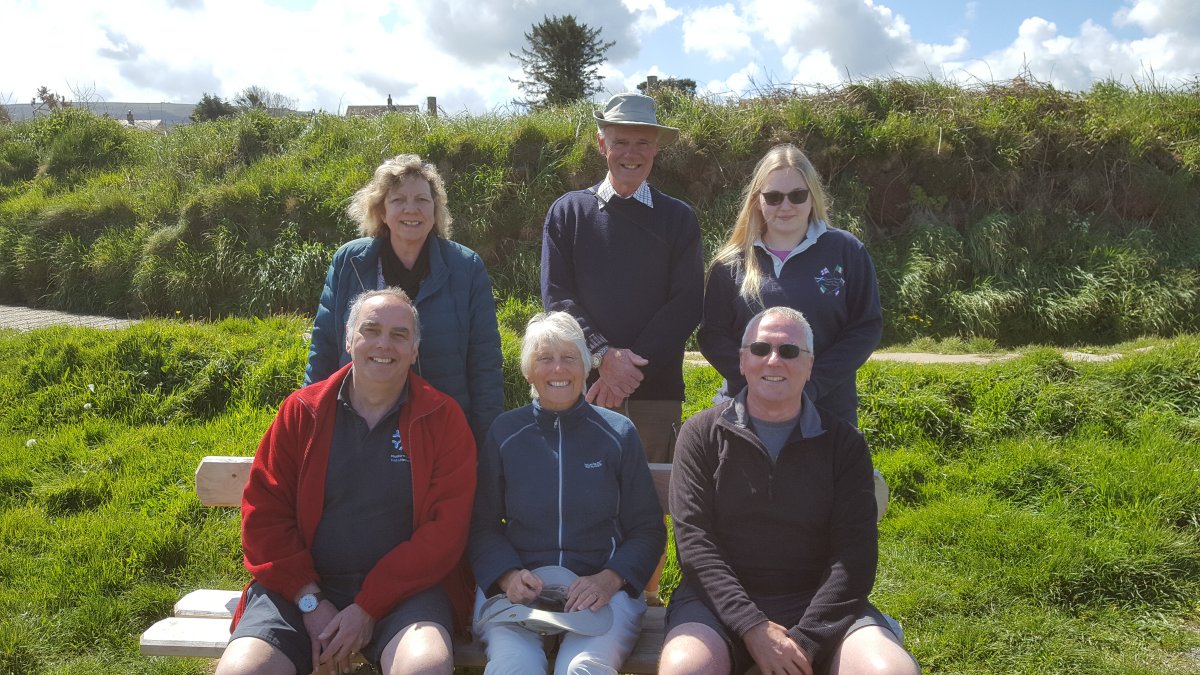 The family group on and around the bench